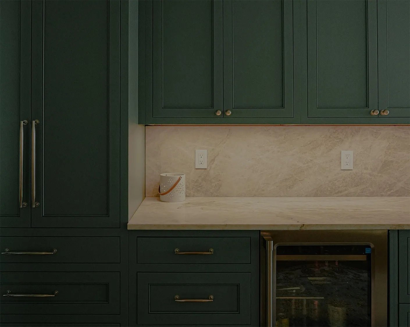 Green kitchen cabinetry with the Ceballos Contracting mark.
